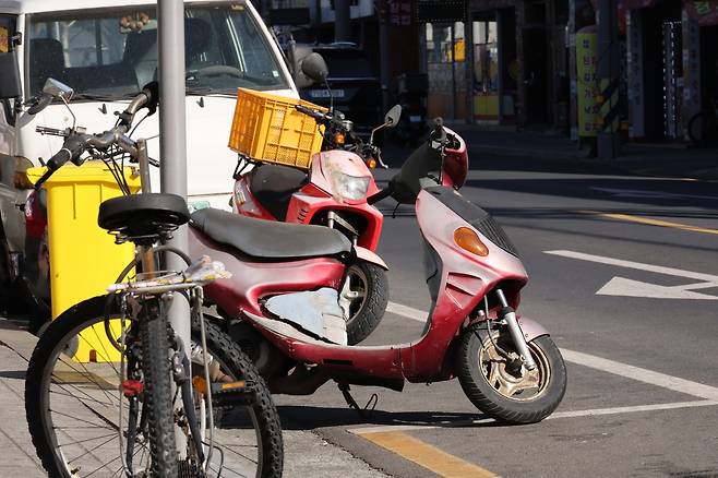 무료 노상 주차장에 세워둔 번호판 없는 오토바이 [촬영 박세진]