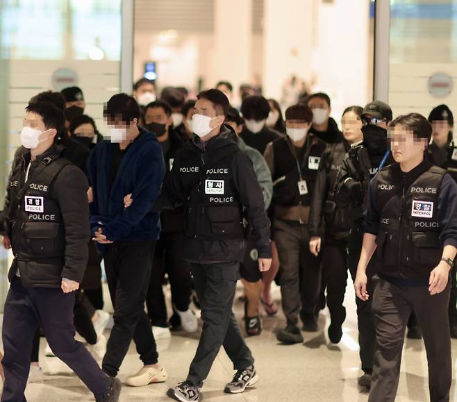 강제 송환된 피의자들이 공항 입국장에서 나오고 있다. 부산경찰청 제공.