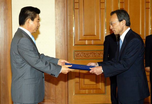 2004년 6월 30일 당시 신임 국무총리에 임명된 이해찬 민주평통 수석부의장이 고 노무현 전 대통령에게 임명장을 받는 모습. 연합뉴스 자료사진