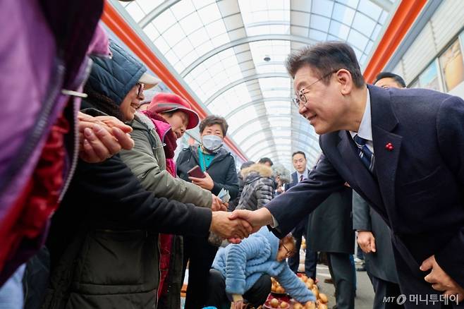 [서울=뉴시스] 최동준 기자 = 이재명 대통령이 23일 울산 울주군 남창옹기종기시장을 방문해 상인들과 인사하고 있다. (사진=청와대 제공) 2026.01.23. photo@newsis.com *재판매 및 DB 금지 /사진=