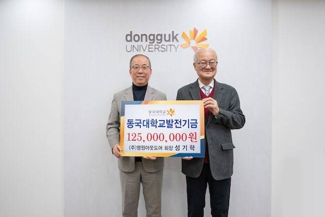 성기학(오른쪽) 영원아웃도어 회장이 지난 4일 동국대 산악부에 1억2500만원을 기부하며 윤재웅 동국대 총장과 기념사진을 촬영하고 있다. /동국대