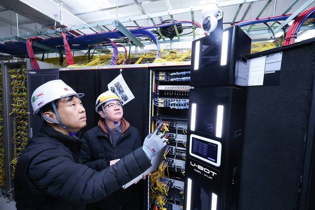 LG유플러스 직원들이 AI 자율주행 로봇 ‘U-BOT’을 점검하고 있다. LG유플러스 제공