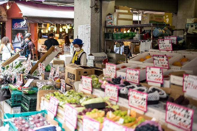 상점 직원이 지난해 8월 22일 일본 도쿄의 한 시장 매장에서 일하고 있다. (사진=AFP)