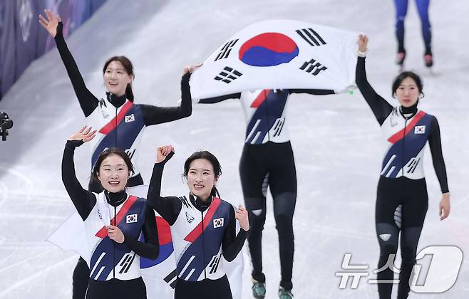 대한민국 여자 쇼트트랙 대표팀이 18일(현지시간) 이탈리아 밀라노 아이스스케이팅 아레나에서 열린 2026 밀라노·코르티나담페초 동계올림픽 쇼트트랙 여자 3000m 계주 결승에서 금메달을 차지한 후 태극기를 두르고 관중석을 향해 인사하고 있다. 2026.2.19 ⓒ 뉴스1 김성진 기자
