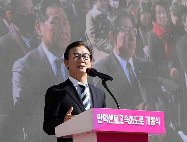 전재수 더불어민주당 의원이 9일 오후 부산 북구 만덕IC 일원에서 열린 ‘만덕~센텀 도시고속화도로’ 개통식에서 축사를 하고 있다. 뒤쪽 전광판 영상에는 박형준 부산시장이 보인다. [뉴스1]