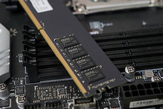 A CXMT DRAM memory module is shown installed on a computer motherboard. CXMT, or ChangXin Memory Technologies, is a Chinese memory chipmaker focused on DRAM production. (CXMT)