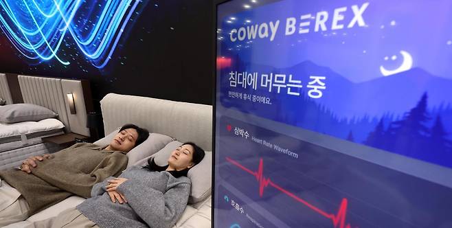 25일 코웨이가 서울 강남구 코엑스 ‘2026 서울리빙디자인페어’에서 공개한 ‘코웨이 비렉스 수면센서 매트리스 S시리즈’를 모델이 직접 체험하고 있다. 코웨이 제공