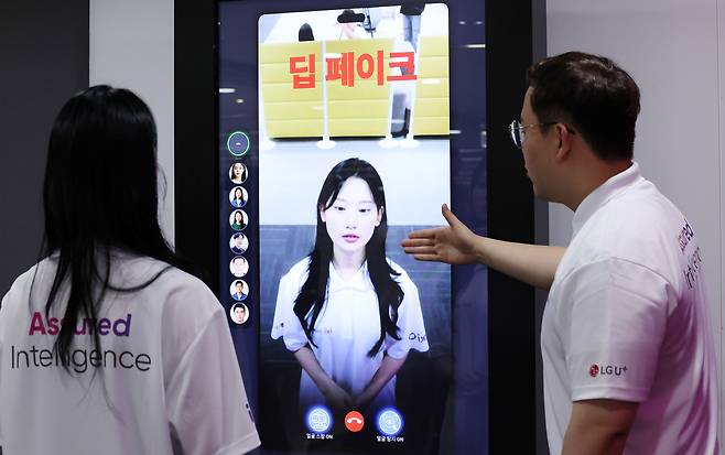 Models demonstrate LG Uplus’s AI anti-deepfake technology during an AI security technology briefing at the LG building in central Seoul on June 26, 2025. [NEWS1]