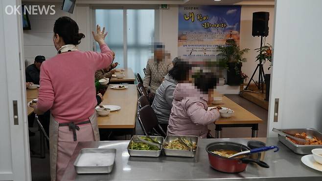 불광동 명동생명의숲교회 무료급식소 배식 창구. 이지희(뒷 모습)씨가 어르신들에게 모자란 음식이 없는지 묻고 있다. 사진=전정희 기자