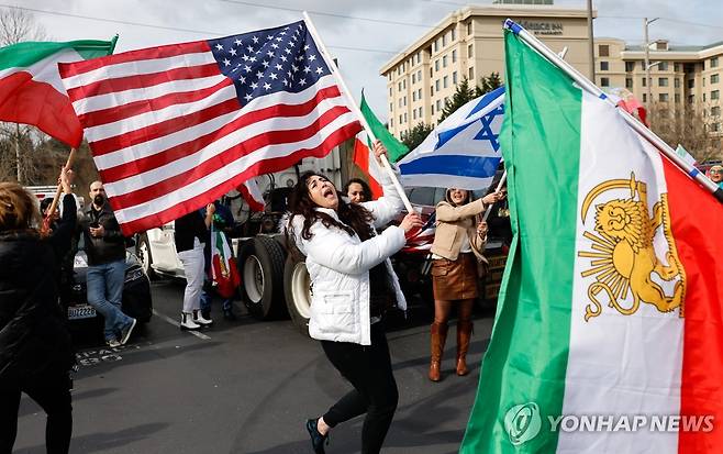 이란 공습을 환영하는 사람들 [AP=연합뉴스. 재판매 및 DB 금지]