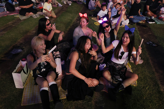 아시아 문화에 대한 관심이 세계적으로 커지는 가운데 지난해 9월 서울 중구 서울광장에서 열린 2025 서울헌터스 페스티벌에서 외국인 관광객들이 넷플릭스 애니메이션 케이팝 데몬 헌터스 수록곡 골든을 부르고 있다. 연합뉴스