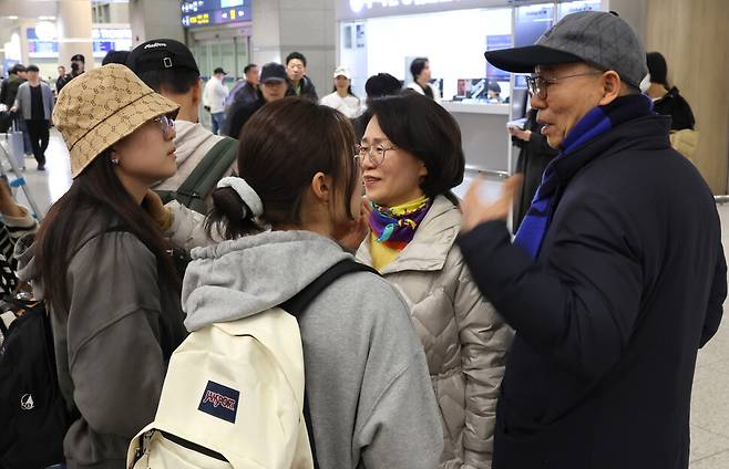 6일 밤 미국·이스라엘과 이란의 전쟁 발발 뒤 처음으로 재개된 두바이발 직항 민항기를 타고 인천국제공항에 도착한 승객들(왼쪽)이 마중 나온 가족과 만나고 있다. 김혜윤 기자 unique@hani.co.kr