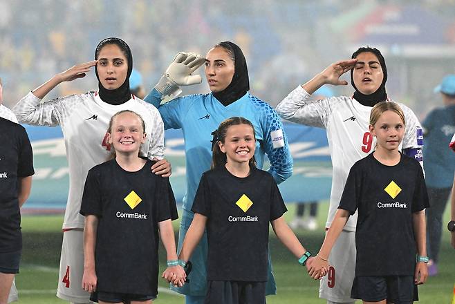 5일 호주 골드코스트 CBUS 슈퍼 스타디움에서 열린 2026 아시아축구연맹(AFC) 여자 아시안컵 조별리그 A조 이란과 호주의 경기에서 이란 선수들이 경기 시작 전 국가가 연주되자 경례하며 제창하고 있다. EPA