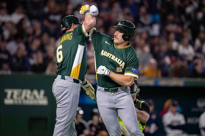 Australia's Alex Hall (R) celebrates with Robbie Glendinning after hitting a solo homerun during the World Baseball Classic (WBC) Pool C first round game between Czech Republic and Australia at the Tokyo Dome in Tokyo on March 6, 2026. AFP연합뉴스