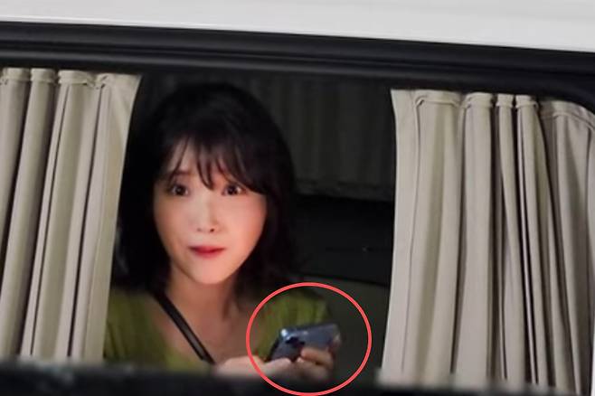 아이유가 퇴근길에 만난 팬들에게 아이폰의 ‘에어드랍’ 기능으로 자신의 셀카를 공유하는 모습이 온라인 상에서 화제가 됐다. 사진은 기사 내용과 무관함. [유튜브(ForYou) 갈무리]