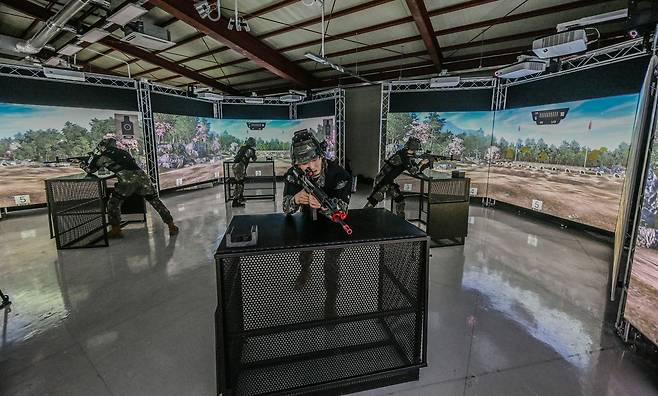 Trainees take part in VR training in front of a three-panel screen at the Seocho Reserve Training Center in southern Seoul. (Republic of Korea Army)