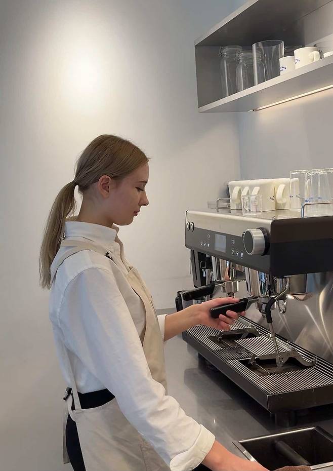 Lea Maxima Septinus from Germany makes coffee at a cafe. [LEA MAXIMA SEPTINUS]