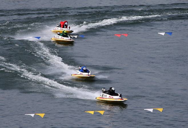 미사 경정장에 등바람이 부는 가운데, 선수들이 결승선을 향해 질주하고 있다. 국민체육진흥공단