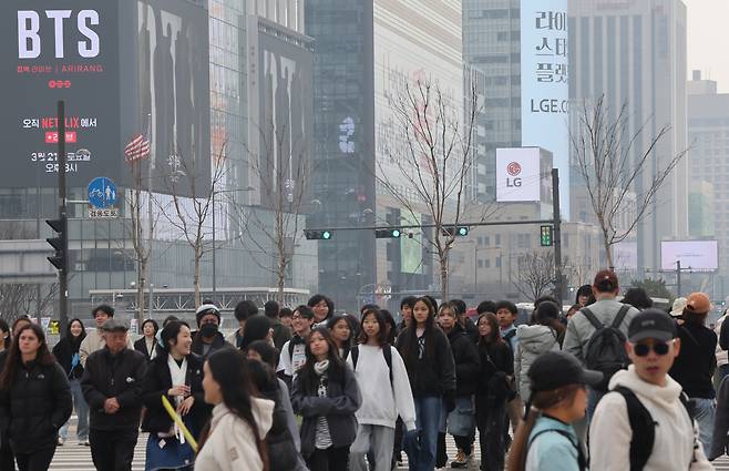 Tourists and residents walk near Gwanghwamun Square in Seoul on Sunday. BTS is scheduled to hold its comeback concert at the site on March 21. (Yonhap)