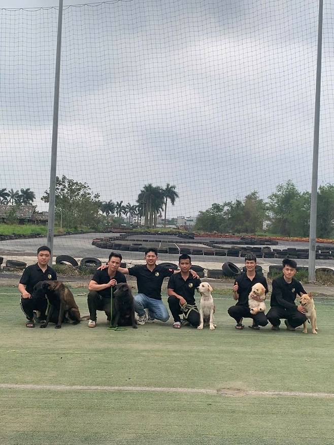 20일 본지가 찾은 베트남 하노이시 소재 한 반려견 훈련소에서 훈련소장 린씨(왼쪽에서 세 번째)를 비롯한 직원들이 각자 훈련을 맡은 반려견들과 기념사진을 촬영하고 있다. 사진=부 튀 띠엔 통신원