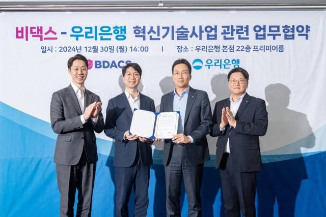 김탁종(왼쪽부터) 비댁스 공동창업자 겸 최고전략책임자(CSO), 류홍열 비댁스 대표, 옥일진 우리은행 디지털혁신그룹장, 윤성후 우리은행 신사업제휴플랫폼부장이 2024년 12월 우리은행 본사에서 업무협약(MOU)을 맺고 기념 촬영을 하고 있다./비댁스 제공