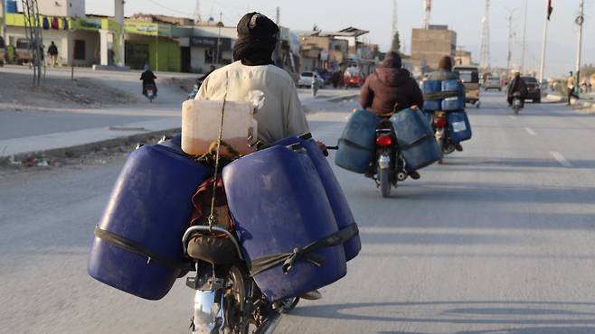 30일, 파키스탄 발루치스탄 주 퀘타 외곽에서 상인들이 오토바이에 휘발유가 가득 든 플라스틱통을 싣고 이동하고 있다. 발루치스탄 주민 다수가 오랫동안 생계 수단으로 삼아온 이란산 밀수 연료 거래는 최근 미국-이스라엘-이란 간 갈등으로 인해 점점 더 큰 타격을 받고 있는데, 이 갈등으로 국경 간 공급 경로가 차질을 빚고 세계 유가가 급등했기 때문이다. 호르무즈 해협과 같은 주요 항로를 통한 해상 운송에 긴장이 영향을 미치고 연료 공급이 위축됨에 따라, 비공식 연료 운송은 더욱 불확실해지고 비용이 증가했으며, 이는 파키스탄 전역과 해당 지역에서 느껴지는 광범위한 경제적 부담과 에너지 공급 차질을 반영하고 있다./EPA 연합뉴스