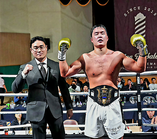 사단법인 한국복싱커미션 헤비급 챔피언 김태광이 2026년 3월 서울과학기술대학교 체육관 특설 링에서 타이틀 1차 성공 후 기념 촬영을 하고 있다. 왼쪽은 대회를 주최한 스페이스 프로모션 양현민 대표. 사진=KBM