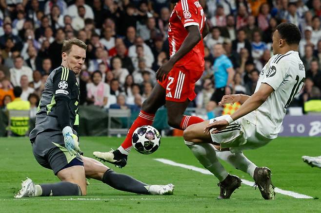 Real Madrid's French forward #10 Kylian Mbappe (R) shoots but fails to score past Bayern Munich's German goalkeeper #01 Manuel Neuer during the UEFA Champions League quarter final first leg football match between Real Madrid CF and FC Bayern Munich at Santiago Bernabeu Stadium in Madrid on April 7, 2026. (Photo by Oscar DEL POZO / AFP)
<저작권자(c) 연합뉴스, 무단 전재-재배포, AI 학습 및 활용 금지>