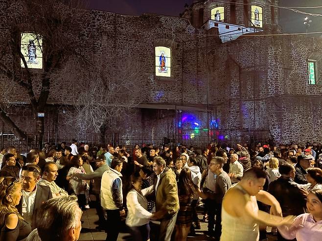 남녀노소 한데 어울려 거리에서 춤을 추는 사람들