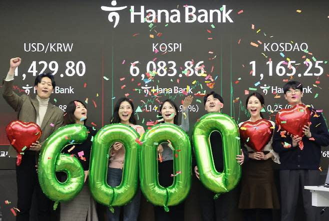 코스피가 종가 기준 사상 처음 6000선을 돌파하자 서울 중구 하나은행 본점 딜링룸에서 직원들이 축하 세리머니를 하고 있다. (사진=뉴스1)