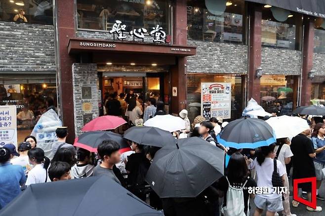 대전의 대표 명소가 된 성심당 본점 앞에 비가 오는 날씨에도 불구하고 빵을 구입하려는 방문객들이 장사진을 이루고 있다. 사진=허영한 기자