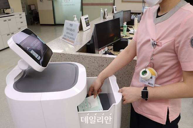 간호사가 이송 로봇을 통해 배달된 약제를 꺼내고 있다. ⓒ한림대의료원
