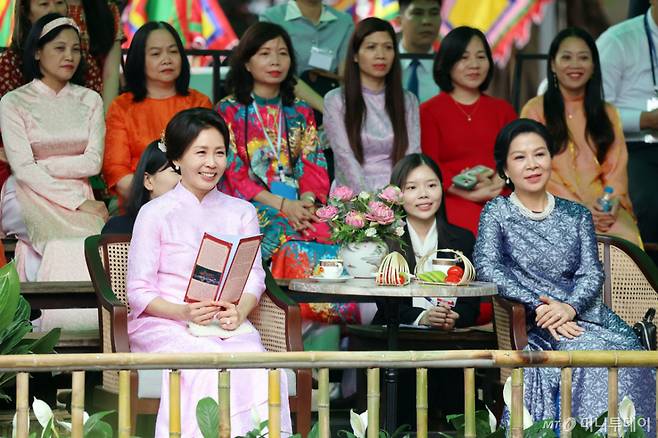 [하노이=뉴시스] 고범준 기자 = 김혜경 여사와 또 럼 베트남 당 서기장 겸 국가주석 부인 응오 프엉 리 여사가 23일(현지 시간) 베트남 하노이 민족학 박물관에서 열린 친교 일정에서 공연 관람을 하고 있다.  김 여사가 착용한 옷은 응오 프엉 리 여사가 선물한 베트남 전통 의상 아오자이다. 2026.04.23. bjko@newsis.com /사진=
