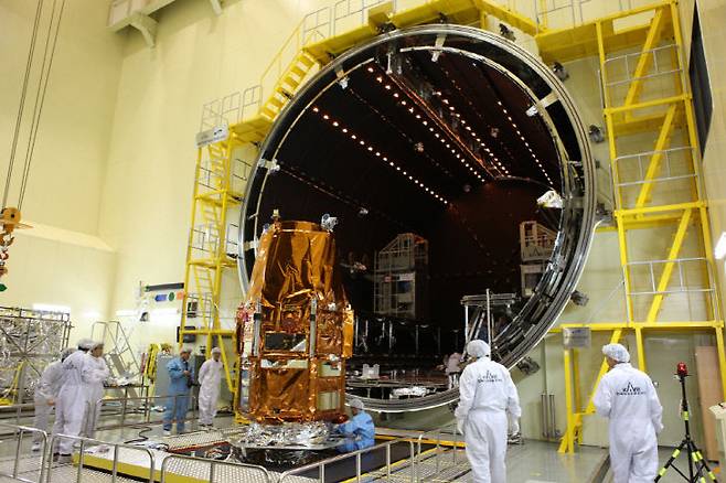 대형열진공챔버 앞에서 우주환경 시험을 준비하는 아리랑 3호와 항우연 연구진 모습. (사진=항우연 제공)