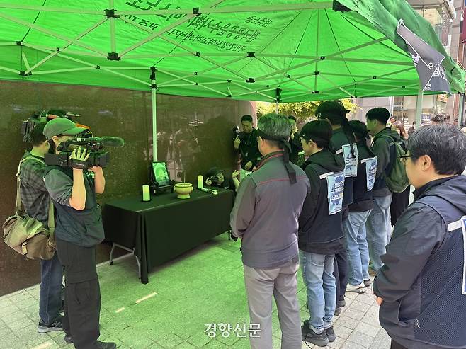민주노총 공공운수노조 조합원들이 27일 서울 강남구 BGF리테일 본사 정문 인근에 설치된 분향소에서 헌화를 마친 뒤 묵념하고 있다. 안효빈 기자