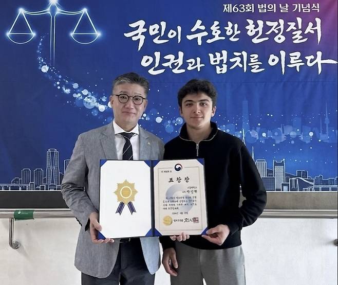 제63회 법의 날 기념식에서 법무부장관 표창을 수상한 서정대학교 박진혁(왼쪽) 교수가 제자인 Odiljonov Bobomurod Inomjon ugli 우즈벡 학생과 함께 기념 촬영을 하고 있다.