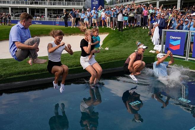 넬리 코다(오른쪽에서 두 번째)가 27일(한국시간) 셰브론 챔피언십에서 우승한 뒤 전통에 따라 캐디,  언니인  제시카 코다  등과 함께  물에 빠지는 세리머니를 하고 있다.  휴스턴  | AP뉴시스