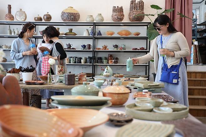 이천도자기축제를 찾은 젊은이들이 공방에서 도자기들을 살펴보고 있다. 이천시 제공