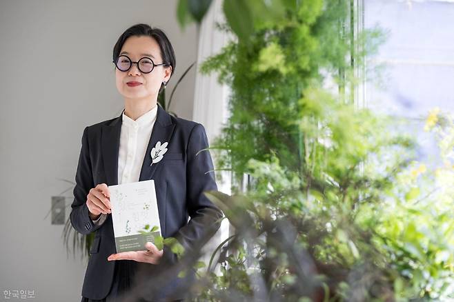 정재경 초록생활연구소 대표가 지난달 23일 경기 성남 분당구 작업실 겸 자택에서 저서 '있는 힘껏 산다'를 들고 포즈를 취하고 있다. 최주연 기자