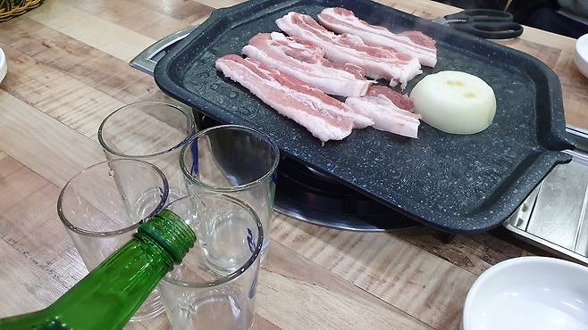 늦은 밤 삼겹살과 소주 한 잔은 잠이 빨리 오는 듯한 느낌을 줄 수 있지만, 새벽 수면을 얕게 만들고 다음 날 컨디션과 혈당 조절에 부담을 줄 수 있다. 게티이미지