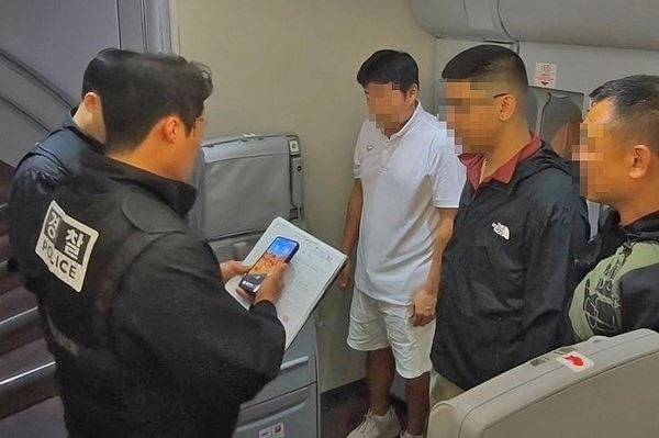 지난 1일 오전 '마약왕' 박왕열에게 필로폰 등 마약류를 공급한 혐의를 받는 최모 씨(흰색 상의)를 태국에서 강제 송환했다. 사진은 기내에서 체포영장을 집행 중인 모습. 사진=경찰청 국가수사본부