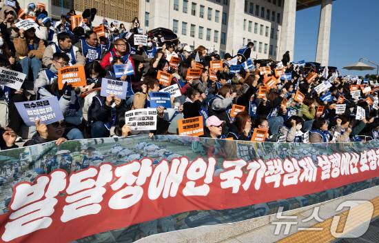 전국장애인부모연대 회원들이 지난해 11월 서울 여의도 국회 본청 앞에서 발달장애인 권리예산 확보를 위한 투쟁 선포 기자회견을 하고 있다. /뉴스1