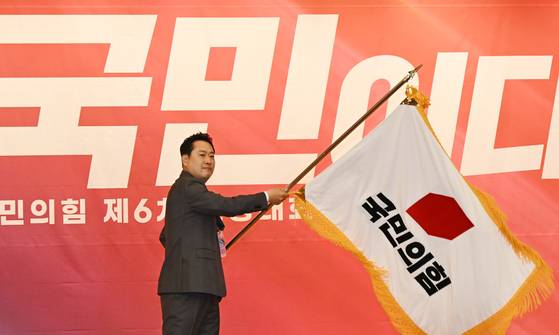 지난해 8월 26일 국민의힘 전당대회에서 선출된 장동혁 대표가 당기를 흔드는 모습. [국회사진기자단]