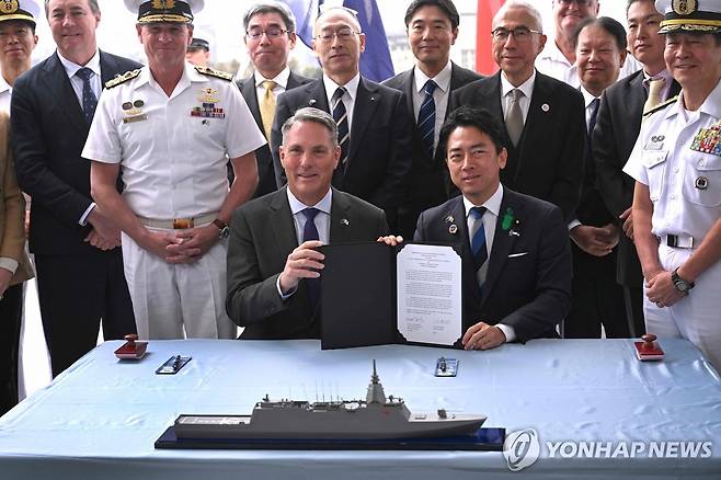 호주, 일본과 모가미급 개량형 호위함 도입 계약 지난달 18일(현지시간) 리처드 말스 호주 부총리 겸 국방부 장관과 고이즈미 신지로 일본 방위상이 멜버른에서 호주 차기 호위함으로 일본 모가미급 개량형 호위함을 도입하는 계약서에 서명한 뒤 사진을 촬영하고 있다.
[AFP 연합뉴스 자료사진. 재판매 및 DB 금지]
