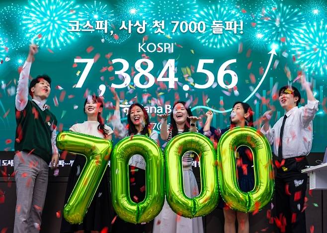 ‘꿈의 7천피’, 코스피 7000 돌파 - 코스피가 장중·종가 기준 처음으로 7000선을 넘어선 6일 서울 중구 하나은행 딜링룸에서 직원들이 축하 세리머니를 하고 있다. 이날 코스피는 전 거래일 대비 447.57 포인트(6.54%) 오른 7384.56에 거래를 마쳤다. 2026.5.6 홍윤기 기자