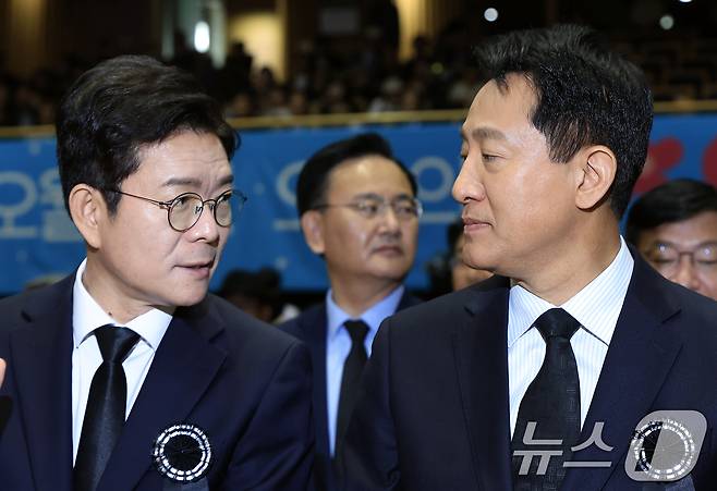 정원오 더불어민주당 서울시장 후보(왼쪽)와 오세훈 국민의힘 서울시장 후보가 18일 오전 서울 중구 서울시청 다목적홀에서 열린 5.18민주화운동 제46주년 서울기념식에서 대화를 나누고 있다. 2026.5.18 ⓒ 뉴스1 박정호 기자