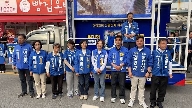 ▲ 6·3 지방선거 공식 선거운동 첫날인 21일 저녁 포천시 신읍사거리 광장에서 열린 더불어민주당 출정식에서 박윤국 포천시장 후보(유세차 위)와 소속 시·도의원 출마자들이 유세차 앞에 나란히 서서 지지자들을 향해 손을 모으며 지방선거 승리를 다짐하고 있다. 이날 유세에는 당내 경선 주자였던 연제창, 손세화, 강준모 전·현직 의원들이 모두 합류해 원팀 화력을 보탰다. /이광덕 기자 kdlee@incheonilbo.com