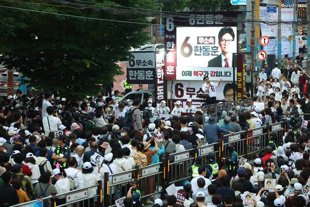 21일 오후 부산 북구 구포시장 쌈지공원에서 열린 무소속 한동훈 부산 북갑 국회의원 보궐선거 후보 출정식에서 지지자들이 연설을 듣고 있다. [연합뉴스]