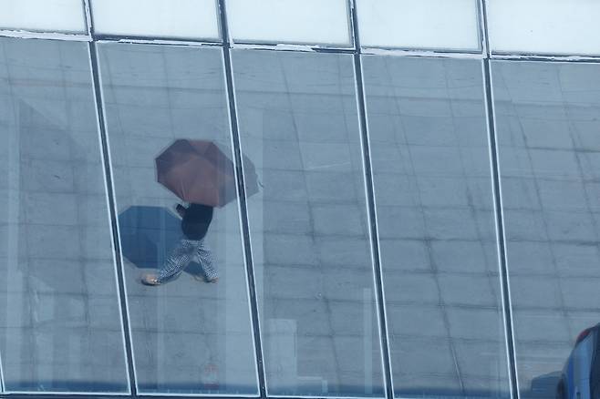 전국 대부분 지역에서 30도를 웃도는 더위가 이어진 2일 서울 영등포구 여의도한강공원에서 한 시민이 양산을 쓰고 이동하고 있다.&nbsp;