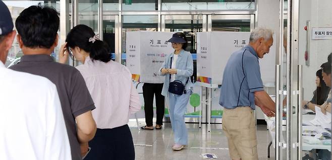 제9회 전국동시지방선거 투표일인 3일 오전 제주시 조천읍 대흘초등학교에 마련된 조천읍제6투표소를 찾은 유권자들이 줄지어 투표하고 있다. 연합뉴스